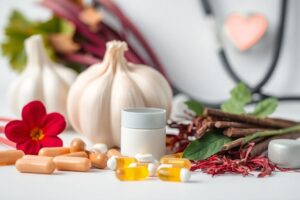 Assorted natural supplements and heart-healthy ingredients like hibiscus, garlic, and saffron representing how supplements can lower blood pressure naturally.