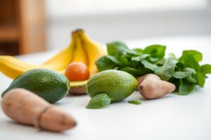 Fresh bananas, spinach, and avocados arranged together, symbolizing potassium’s role in balancing blood pressure naturally.