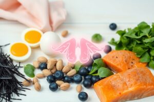 Flat lay of colorful thyroid-friendly foods like seaweed, eggs, salmon, Brazil nuts, spinach, and berries on a white background representing a healthy thyroid diet for women.