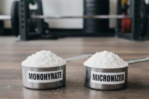 Creatine monohydrate and micronized creatine scoops side by side, showing texture difference.
