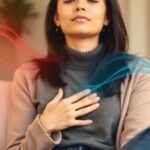 Woman practicing breathing exercise to break the anxiety and shortness of breath cycle, with visual representation of calm vs. anxious states.