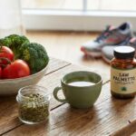 A collection of natural remedies for prostate health: fresh vegetables, supplements, pumpkin seeds, and green tea on a wooden table.